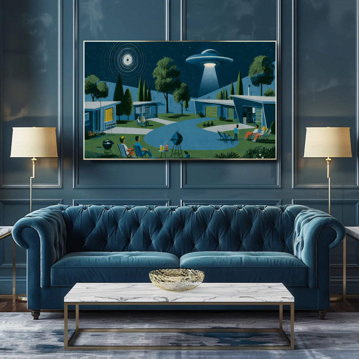 A framed art print depicting a retro 1950s suburban backyard with a flying saucer and UFO, displayed on a dark blue paneled wall above a matching blue tufted sofa in a modern living room setting.