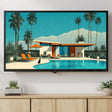 A framed art print depicting a mid-century modern house with a swimming pool, palm trees, and mountains, displayed on a wall above a light wood console cabinet in a styled living room setting.