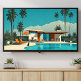A framed art print depicting a mid-century modern house with a swimming pool, palm trees, and mountains, displayed on a wall above a light wood console cabinet in a styled living room setting.