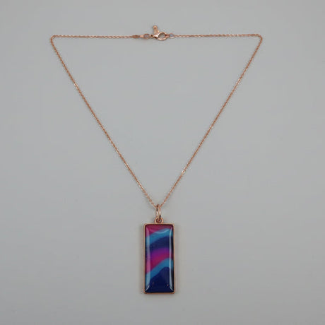 Necklace with a colorful rectangular pendant on a light gray background